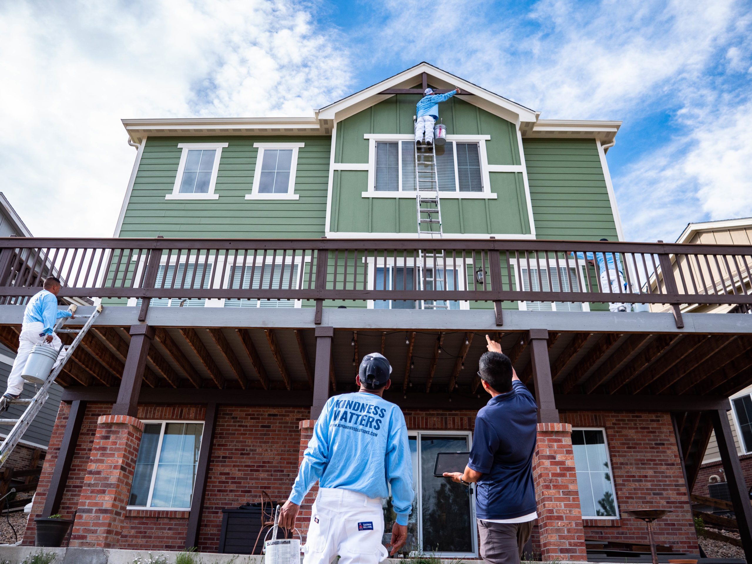 kind home painting team on an exterior paint job