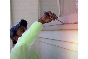 photo of kind home painter scraping paint